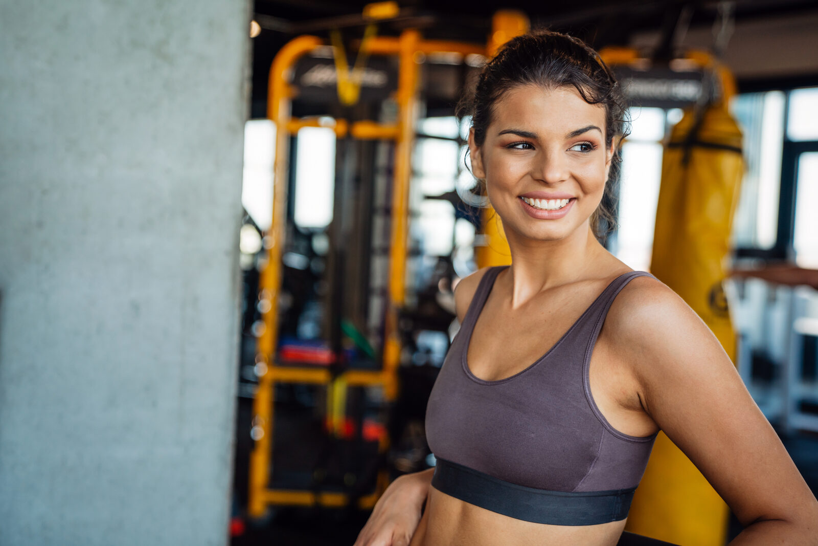 Trainer guiding a TrimRx member on gym equipment